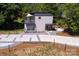 Aerial view of the home featuring a unique driveway, modern architecture, and a private balcony with landscaping at 6534 Providence Rd, Charlotte, NC 28226