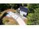 Aerial view of a modern home with a geometric driveway, a dark metal roof, and a private balcony overlooking the property at 6534 Providence Rd, Charlotte, NC 28226