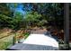Backyard featuring a concrete patio, stone retaining wall, and beautiful landscaping at 6534 Providence Rd, Charlotte, NC 28226