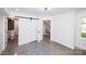 Finished basement featuring polished concrete floors and barn doors to a bathroom at 6534 Providence Rd, Charlotte, NC 28226