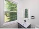Stylish bathroom features a sleek vanity with modern fixtures and a large window at 6534 Providence Rd, Charlotte, NC 28226