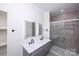 This updated bathroom features double sinks, modern fixtures, and a large tile shower at 6534 Providence Rd, Charlotte, NC 28226
