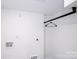 A simple closet space with white walls and a metal rack offers practical storage solutions at 6534 Providence Rd, Charlotte, NC 28226