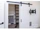 Spacious closet features custom shelving and storage with a unique barn door at 6534 Providence Rd, Charlotte, NC 28226