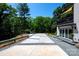 Long driveway with gravel accents leading to a modern home with lovely landscaping at 6534 Providence Rd, Charlotte, NC 28226