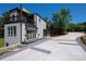 Striking home showcasing a modern design, private balcony and a unique driveway complemented by lush landscaping at 6534 Providence Rd, Charlotte, NC 28226