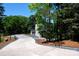 Home exterior with a long driveway and lush surrounding landscaping at 6534 Providence Rd, Charlotte, NC 28226