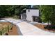 Exterior of home featuring modern construction, a spacious driveway, and lovely landscaping at 6534 Providence Rd, Charlotte, NC 28226