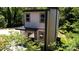 Modern exterior with a metal roof, dark trim, and surrounded by mature trees at 6534 Providence Rd, Charlotte, NC 28226