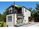 A contemporary two-story home featuring a balcony, modern siding and lush landscaping at 6534 Providence Rd, Charlotte, NC 28226