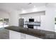 Bright kitchen with white cabinets, stainless steel appliances, and a granite island at 6534 Providence Rd, Charlotte, NC 28226