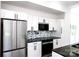 Well-lit kitchen featuring stainless steel appliances and granite countertops at 6534 Providence Rd, Charlotte, NC 28226