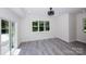 Bright living room boasts a modern ceiling fan, and beautiful views from large windows at 6534 Providence Rd, Charlotte, NC 28226