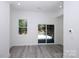 Living room with hardwood floors, recessed lights, and sliding glass doors to the patio at 6534 Providence Rd, Charlotte, NC 28226