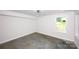 A brightly lit room features a modern ceiling fan, a window, and a concrete floor at 6534 Providence Rd, Charlotte, NC 28226