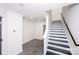 Bright white staircase with black accents complements the modern design of this home's lower level living area at 6534 Providence Rd, Charlotte, NC 28226
