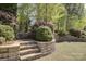 Backyard with tiered retaining wall and landscaped garden at 10029 Daufuskie Dr, Charlotte, NC 28278