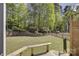 View of level backyard features retaining wall and a black fence at 10029 Daufuskie Dr, Charlotte, NC 28278