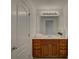 Well-lit bathroom showcasing a wooden vanity with ample storage and a large mirror at 10029 Daufuskie Dr, Charlotte, NC 28278