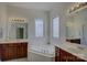 Luxurious bathroom featuring double vanities, a soaking tub, and stylish fixtures at 10029 Daufuskie Dr, Charlotte, NC 28278