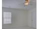 Neutral bedroom with a ceiling fan, window with blinds, and carpet floors at 10029 Daufuskie Dr, Charlotte, NC 28278