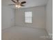 Neutral bedroom with plush carpet, natural light, and a ceiling fan at 10029 Daufuskie Dr, Charlotte, NC 28278