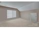 Bright bonus room featuring a window with blinds and neutral decor at 10029 Daufuskie Dr, Charlotte, NC 28278