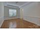 Inviting room with hardwood floors, wainscoting, and a tray ceiling, perfect for formal dining at 10029 Daufuskie Dr, Charlotte, NC 28278
