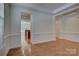 Open room with hardwood floors and a view into the kitchen, perfect for entertaining at 10029 Daufuskie Dr, Charlotte, NC 28278