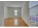 Spacious, bright room with hardwood floors and large windows offering plenty of natural light at 10029 Daufuskie Dr, Charlotte, NC 28278
