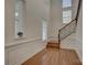 Bright foyer featuring beautiful staircase, hardwood floors, and wainscoting at 10029 Daufuskie Dr, Charlotte, NC 28278