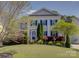 Charming two-story home with a well-manicured lawn and colorful landscaping, inviting curb appeal at 10029 Daufuskie Dr, Charlotte, NC 28278
