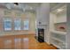 Bright living room with large windows, hardwood floors, and a cozy fireplace at 10029 Daufuskie Dr, Charlotte, NC 28278