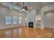 Elegant living room featuring a fireplace, built-in shelves, and large windows at 10029 Daufuskie Dr, Charlotte, NC 28278