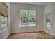 Bright room featuring hardwood floors, a large window, and a door to the outside at 10029 Daufuskie Dr, Charlotte, NC 28278