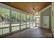 Charming screened-in porch with wood floors and view of the lush backyard at 10029 Daufuskie Dr, Charlotte, NC 28278