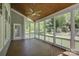Screened porch with wood ceiling and flooring overlooks manicured backyard at 10029 Daufuskie Dr, Charlotte, NC 28278