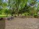 Serene backyard featuring a stone patio, lounge furniture, and a tranquil atmosphere at 1655 Scotland Ave, Charlotte, NC 28207