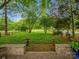 Expansive backyard featuring a lush green lawn, mature trees, and a classic wooden fence at 1655 Scotland Ave, Charlotte, NC 28207