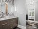 Contemporary bathroom with decorative mirror, custom vanity, and designer fixtures at 1655 Scotland Ave, Charlotte, NC 28207