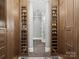 Organized walk-in closet with custom shelving for shoes and accessories at 1655 Scotland Ave, Charlotte, NC 28207