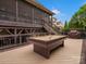 Outdoor deck featuring a pool table, covered seating, and backyard views at 1655 Scotland Ave, Charlotte, NC 28207