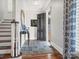Inviting entryway features slate floors, a wooden staircase, and a gray front door at 1655 Scotland Ave, Charlotte, NC 28207