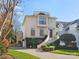 Beautiful home featuring a curved stairway leading to the front door and mature landscaping at 1655 Scotland Ave, Charlotte, NC 28207