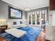 Bright living room with a cream sofa, blue rug, large picture window, and elegant chandelier at 1655 Scotland Ave, Charlotte, NC 28207