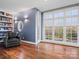 Bright living room with large windows, custom blinds, and a cozy reading nook with built-in shelving at 1655 Scotland Ave, Charlotte, NC 28207