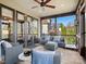 Relaxing screened porch with comfortable seating, a ceiling fan, and views of the surrounding neighborhood at 1655 Scotland Ave, Charlotte, NC 28207
