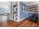 Cozy sitting area featuring custom built-in bookshelves and a comfortable armchair for reading and relaxation at 1655 Scotland Ave, Charlotte, NC 28207