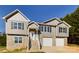 Two-story house with gray siding, stone accents, and a two-car garage at 2061 Gary Ln, Hickory, NC 28602