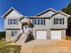Two-story house with gray siding, stone accents, and a two-car garage at 2061 Gary Ln, Hickory, NC 28602